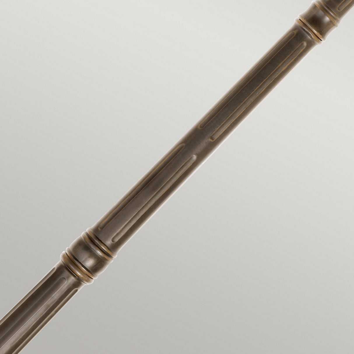 Close-up of the Tournai 3 Light Extra Large Lamp Post in bronze, featuring decorative grooves and smooth bands, radiating vintage charm against a light gray background.