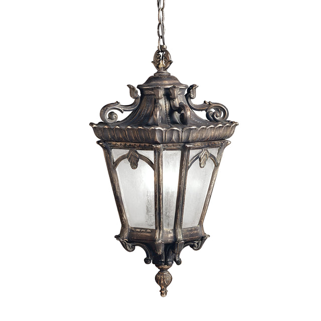 The Tournai Outdoor 4 Light Grand Extra Large Chain Pendant in Bronze boasts a vintage design with intricate metalwork and frosted glass panels. Suspended by a chain, this outdoor pendant features a decorative top, ornate details, and a classic, weathered finish that lends timeless elegance to any space.