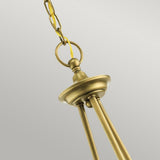 A close-up of the Waverly 5 Light Chandelier in natural brass, showcasing its vintage-style design with a decorative chain and ring, suspended against a neutral background. The chandelier features a smooth, elegant finish.