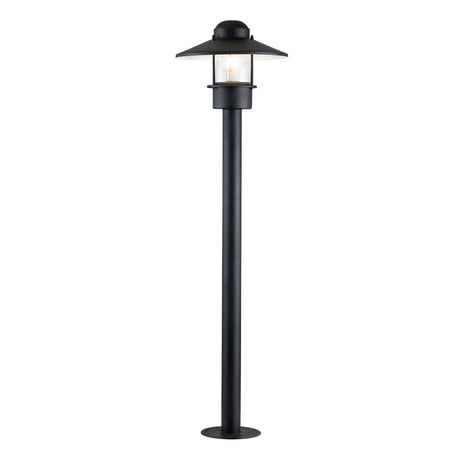 Introducing the Klampenborg 1 Light Bollard - Black, a tall outdoor lamp post with a modern design. It features a clear glass enclosure housing a light bulb and boasts a sleek pole reminiscent of the Klampenborg style. Its pointed roof and round base add an elegant touch to any outdoor lighting arrangement.