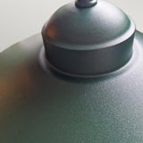Close-up of the Klampenborg 1 Light Outdoor Wall Light in green, featuring a curved, dome-shaped top with a smooth matte finish. Its Scandinavian design combines modern aesthetics with functionality, making it ideal against neutral backgrounds. Additionally, its IP44 rating ensures durability across various weather conditions.
