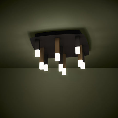 Korbelle 9 Light Ceiling Light with a black square plate and nine staggered black, brown and gold rods ending in frosted diffusers, shown illuminated on a ceiling.