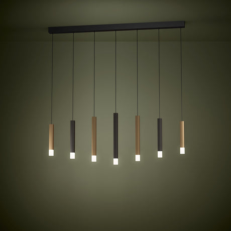 Korbelle Linear Pendant Light with black ceiling bar and seven staggered black, brown, and gold square tubes ending in glowing satin diffusers, shown illuminated.