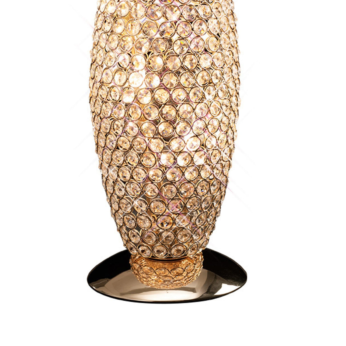 The Kos 3 Light Crystal Table Lamp in French Gold features a gold base and an oval body adorned with sparkling crystal-like gems, casting a warm, glowing light.