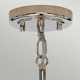 Close-up of the Kula 5 Light Chandelier in polished nickel, showcasing its modern retro style. The fixture is designed with a round base and a hanging chain, featuring visible electrical wiring. Its glass shades enhance the elegant touch of the shiny, reflective finish.