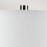 Close-up of the top portion of a white fabric lampshade with a small shiny metallic finial on top, enhancing the sleek design of the Laguna 1 Light Small Table Lamp in Turquoise & Graphite Glaze, set against a plain light gray background.