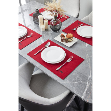 Lakandava Placemat in red with embroidered deer detail, styled on a marble dining table with white plates, cutlery, candles and dried flowers.