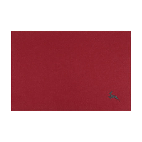 Lakandava Placemat in deep red, a rectangular felt-textured table mat with a small dark grey embroidered leaping deer near one corner, shown on a plain white background.