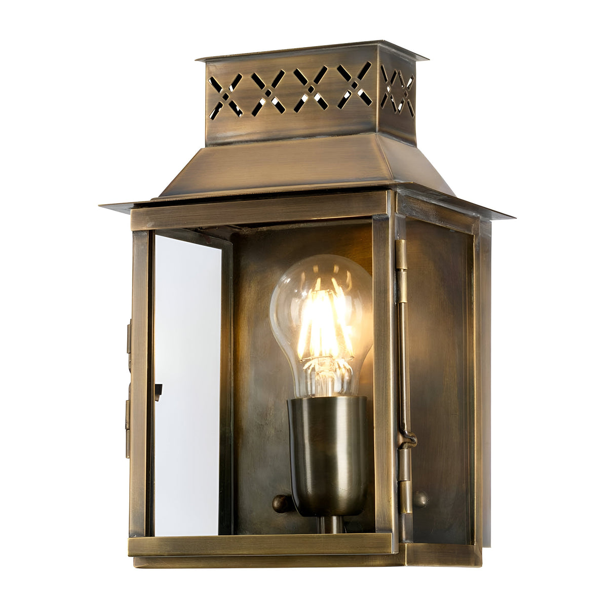 The Lambeth Palace 1 Light Outdoor Wall Light - Aged Brass boasts a glass enclosure with a visible glowing bulb, radiating vintage charm. Its aged brass finish and ornate cut-out patterns on the top enhance elegance in any outdoor environment.