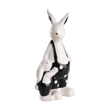 Landjut ceramic rabbit ornament, a tall white rabbit in black polka-dot dungarees with gold nose detail, beside a smaller rabbit with pink cheeks, set on a plain white background.