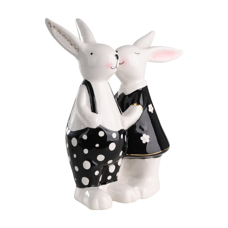 Landjut ceramic rabbit ornament showing two glossy white rabbits kissing, one in black polka-dot dungarees, the other in a black floral dress, with gold ear and cuff accents, on a white background.
