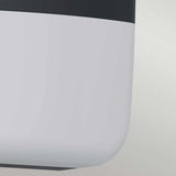 Close-up of the Lars LED Outdoor Wall Light - Black, featuring a modern aesthetic with a smooth, rounded design. It showcases a sleek two-tone color scheme with a dark grey top and light grey bottom against a light background. This IP65-rated piece emphasizes minimalist design and texture.