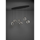 Larva Linear Pendant Light in black steel with six smoked glass shades of staggered barrel and globe shapes, suspended from a long oval ceiling plate against a dark background.