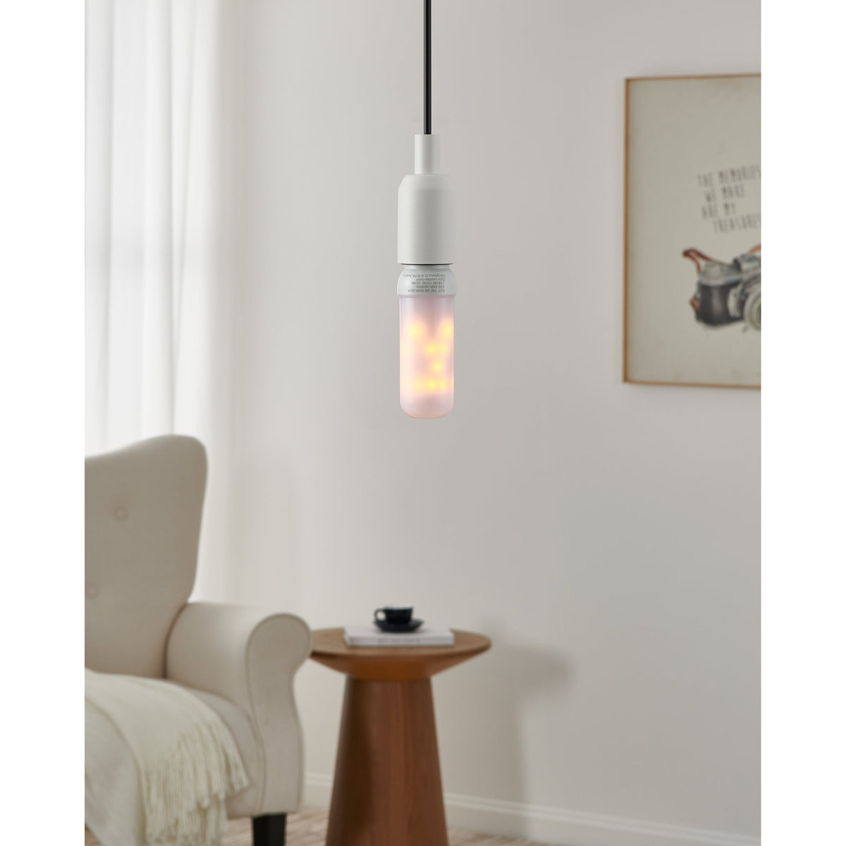 Slim tubular LED bulb, E27 fitting, 3W warm white, opal frosted cover, shown lit in a white pendant fixture above a living room side table.