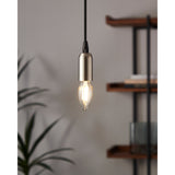 Pendant light with brushed nickel fitting and black cord holding an LED candle bulb E14 C35, lit warm white, shown in a room beside wooden shelving and a plant.