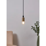 Pendant light with wood-effect holder and black cord fitted with an LED golf ball bulb, E27 glass globe glowing warm white, shown above a beige sofa near a green plant.