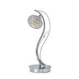 Leimo 1 Light Crystal Table Lamp features a polished chrome finish, a curved decorative stem, a spherical crystal-accented shade, and stands on a round base.