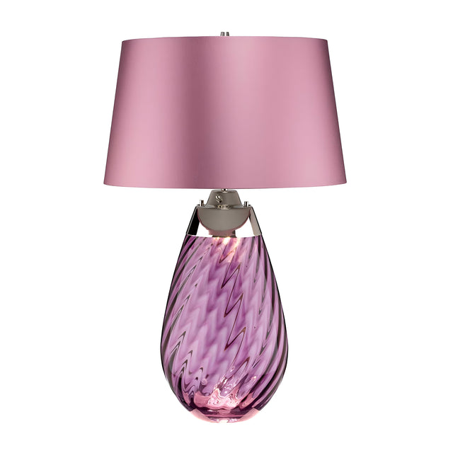 The Lena 2 Light Large Plum Table Lamp with a Heather Shade offers a stylish contemporary design, featuring a light purple mouth-blown glass base embellished with an elegant swirl pattern, and completed by a smooth matching purple shade. This refined piece enhances any room with its sophisticated charm.