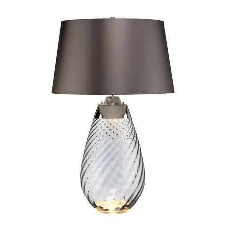 Introducing the Lena 2 Light Large Smoke Table Lamp with a slate shade, featuring a transparent, smoke-tinted glass base with an elegant spiral design. The gray lampshade complements its slightly illuminated Dual-Lit system, adding a touch of sophistication to any room.