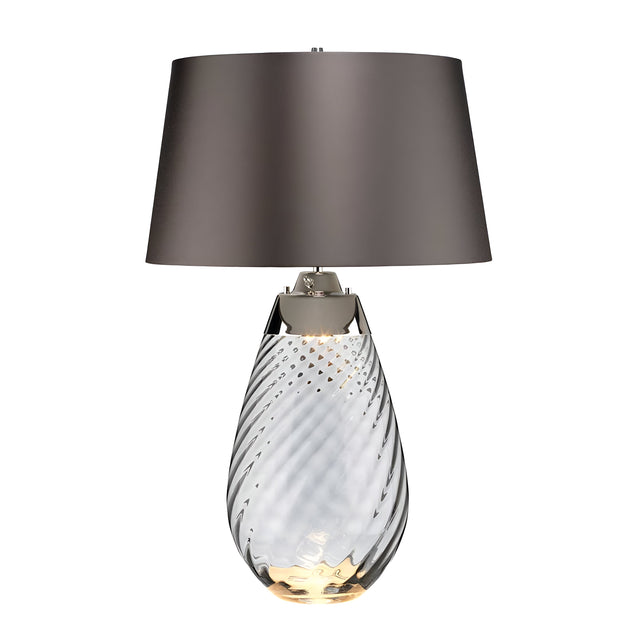 Introducing the Lena 2 Light Large Smoke Table Lamp with a slate shade, featuring a transparent, smoke-tinted glass base with an elegant spiral design. The gray lampshade complements its slightly illuminated Dual-Lit system, adding a touch of sophistication to any room.