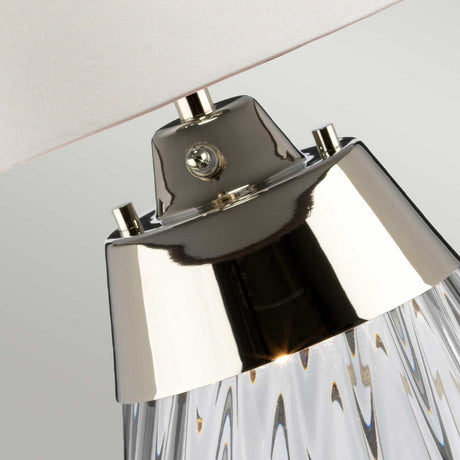 Close-up of the Lena 2 Light Small Smoke Table Lamp - Off-White Shade, highlighting its sleek metallic neck and smoke-tinted glass body. The off-white shade complements the Dual-Lit system, all set against a plain light background.