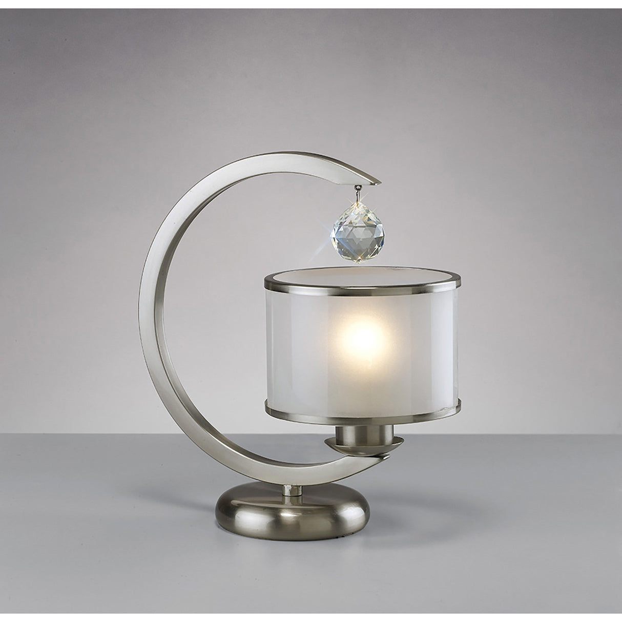 The Lincoln 1 Light Crystal Table Lamp features a modern satin nickel frame, glass shade, and crystal accent, creating a stylish look against a plain gray background.