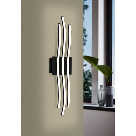 Livette LED 3 Light Flush Ceiling Light in black, mounted on a wall near a window, with three wavy bars and white diffusers on a rectangular base.