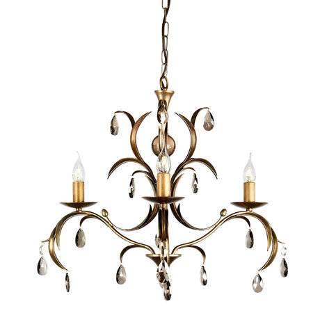 The Lily 3 Light Chandelier - Bronze Patina showcases an elaborate design featuring three candle-shaped lights, complemented by smoked cut glass droplets elegantly draped from its gracefully curved arms. This chandelier is finished with a hand-patinated bronze look and is suspended by a decorative chain.