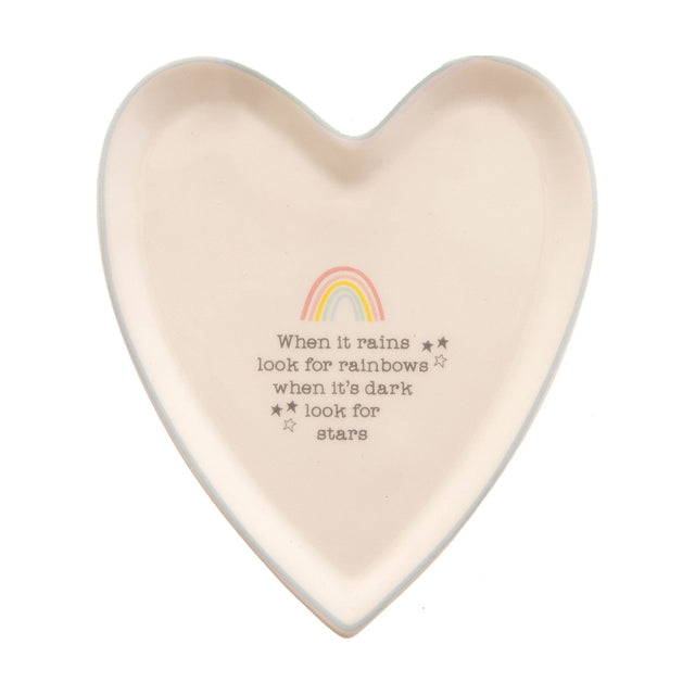 White ceramic heart-shaped trinket dish with pale blue rim, pastel rainbow design, star accents, and grey quote text, shown on a plain white background.