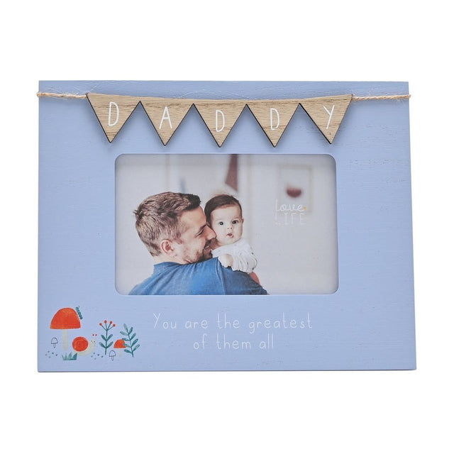 Blue wooden 6x4in photo frame with natural wood "DADDY" bunting on twine above a father and baby photo, with "You are the greatest of them all" text and mushroom motif.