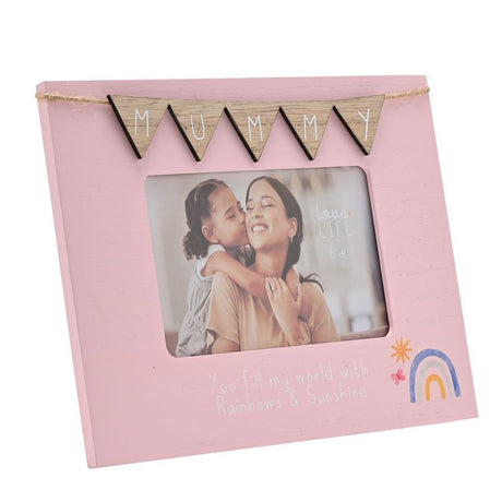 Pink wooden 6x4in photo frame with "MUMMY" wooden bunting flags on twine, holding a mother-daughter photo, with "You fill my world with Rainbows & Sunshine" text and a rainbow motif below.