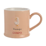 Peach stoneware mug with a white embossed goose, "Wonderful" in grey script and "GRANDMA" in red capitals, white interior, on a plain background.