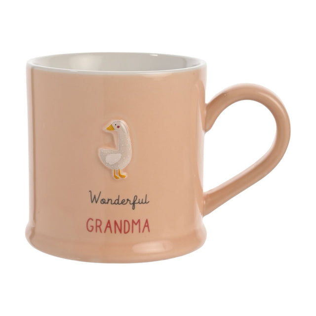 Peach stoneware mug with a white embossed goose, "Wonderful" in grey script and "GRANDMA" in red capitals, white interior, on a plain background.