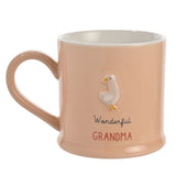 Peach stoneware mug with white interior and a raised white goose design, reading "Wonderful GRANDMA" in grey script and red capitals, set on a plain background.