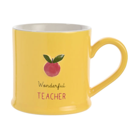 Yellow stoneware mug with a white interior, featuring an embossed red apple with green leaves above "Wonderful Teacher" text, shown against a plain white background.