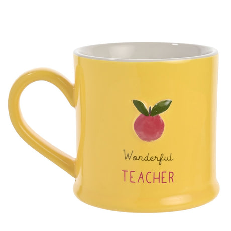 Yellow stoneware mug with white interior and C-shaped handle, featuring an embossed red apple with green leaves above "Wonderful Teacher" text, shown on a plain white background.
