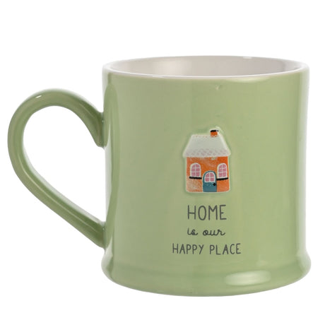 Green glazed stoneware mug with a white interior, featuring an embossed house design and the printed text "HOME is our HAPPY PLACE" on a plain background.