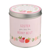 Round pink tin scented candle with silver lid, printed "Sister you are the Berry Best" text and strawberry, ladybird, and floral illustrations, on a white background.