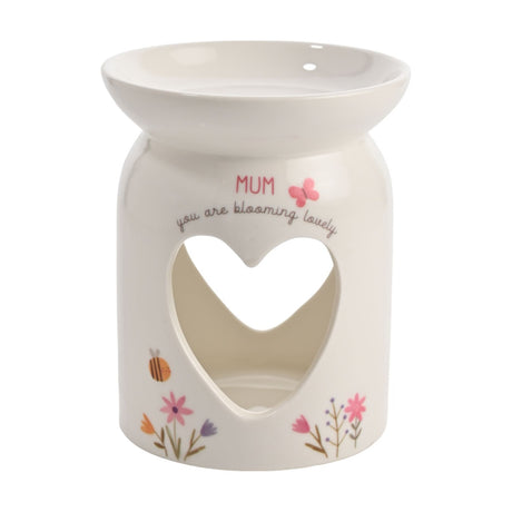 White ceramic wax melt burner with a wide top dish and heart cutout, printed "MUM, you are blooming lovely" with a pink butterfly and floral details, on a plain background.