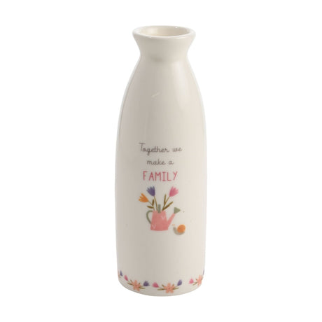 White ceramic stem vase with "Together we make a FAMILY" script text, a pink watering can with tulips, tiny snail, and floral border, on a plain background.