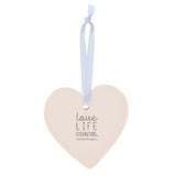 White ceramic heart-shaped hanging decoration with pale blue ribbon, reverse side printed with "Love Life Celebrations" text, shown on a plain white background.