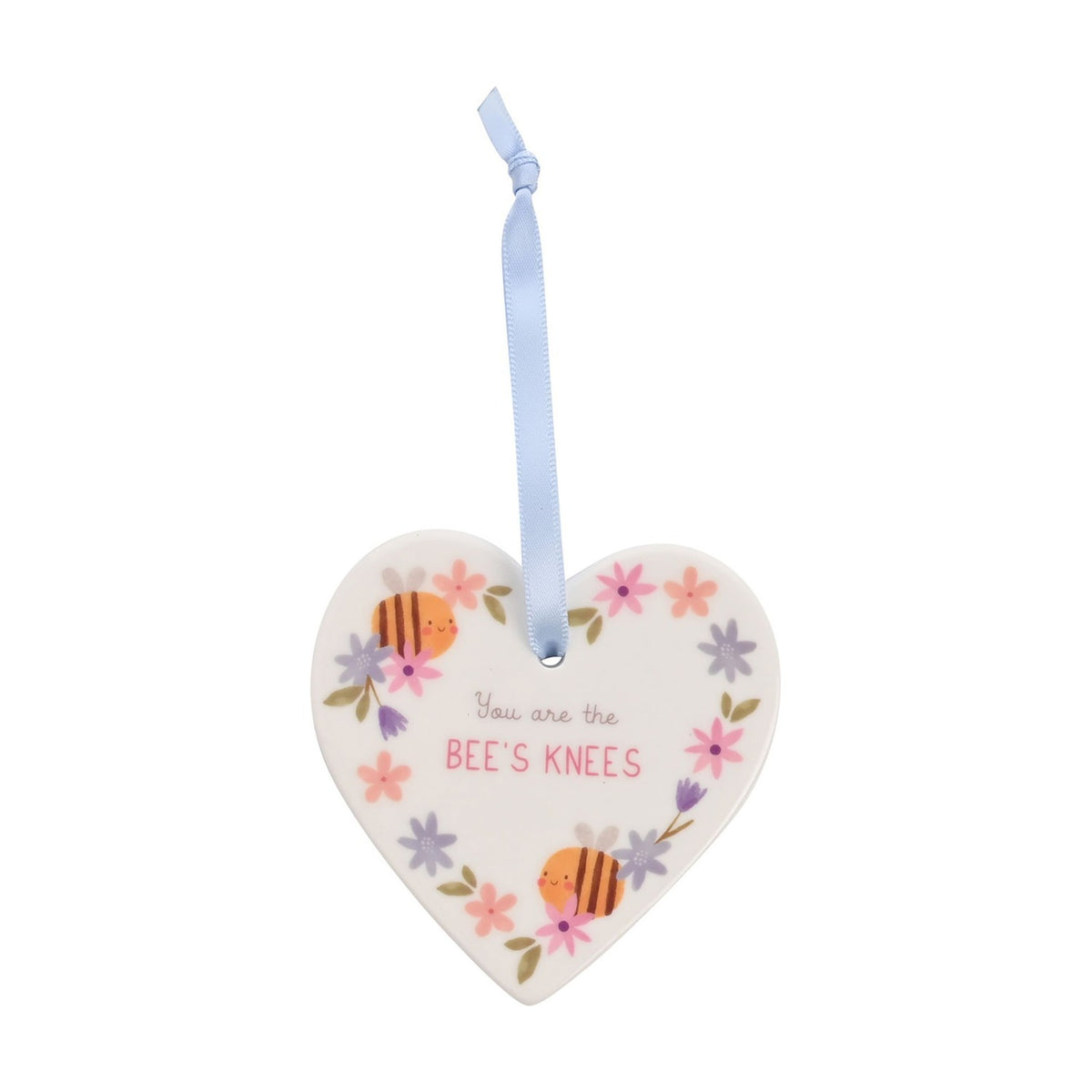 White ceramic heart-shaped hanging decoration with pastel floral border, smiling bees, and "You are the BEE'S KNEES" text, hung by a pale blue ribbon on a white background.