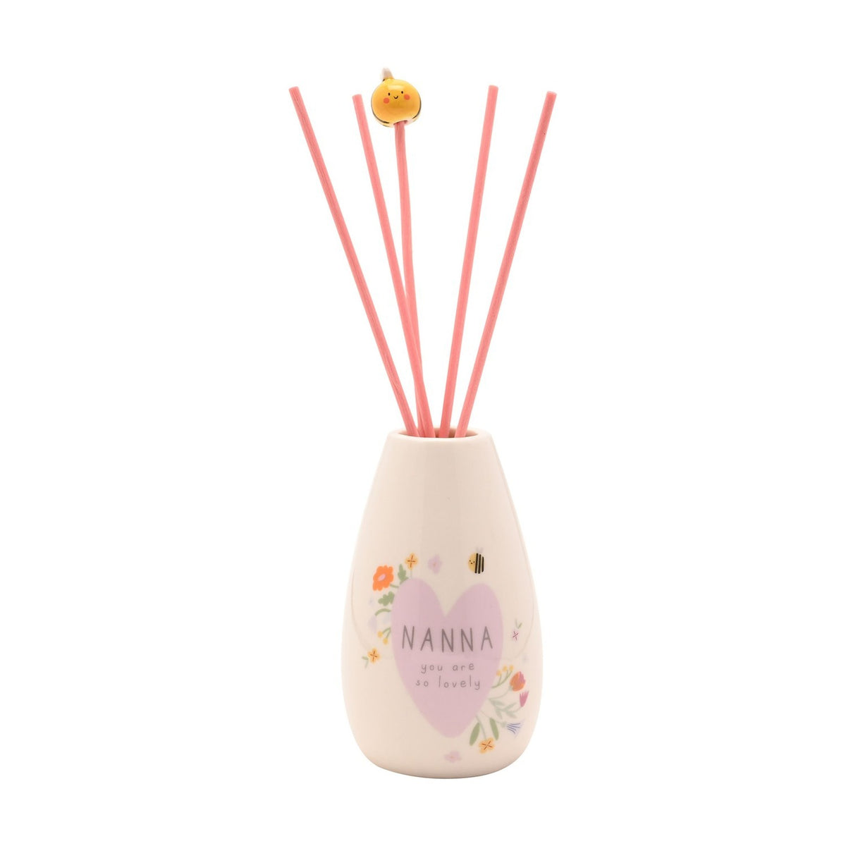 Ceramic reed diffuser with rounded cream body, lilac heart reading "NANNA you are so lovely" amid floral and bee details, pink reeds topped with a yellow bee, on a white background.