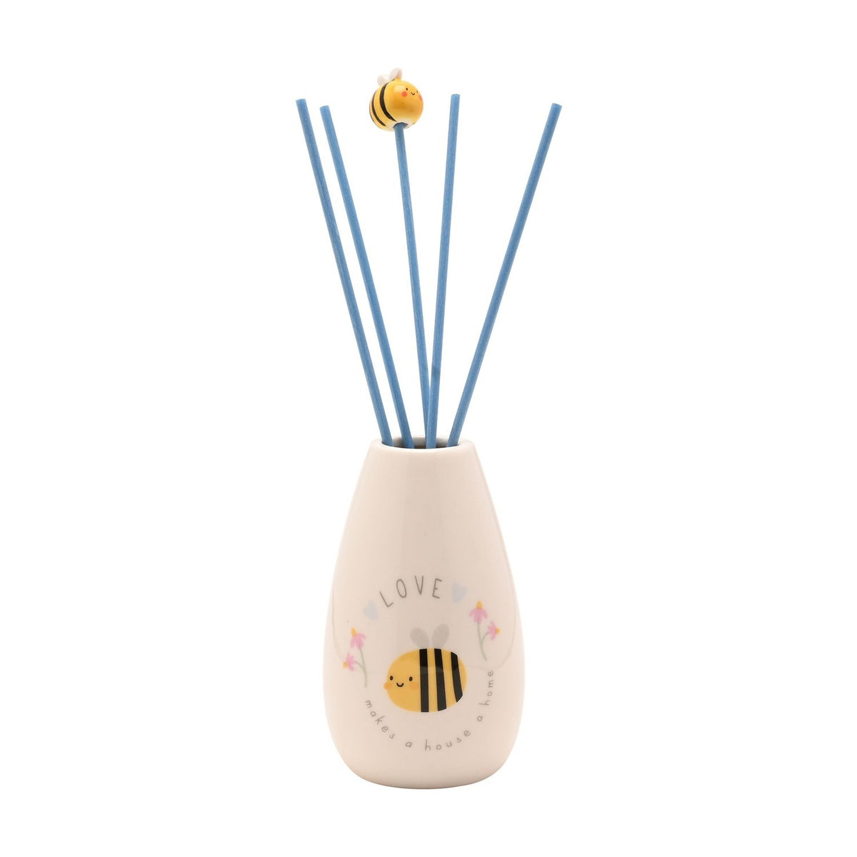 Cream ceramic reed diffuser with a teardrop base printed with a smiling bee, wildflowers and "LOVE makes a house a home," blue reeds topped with a tiny bee bead, on a white background.