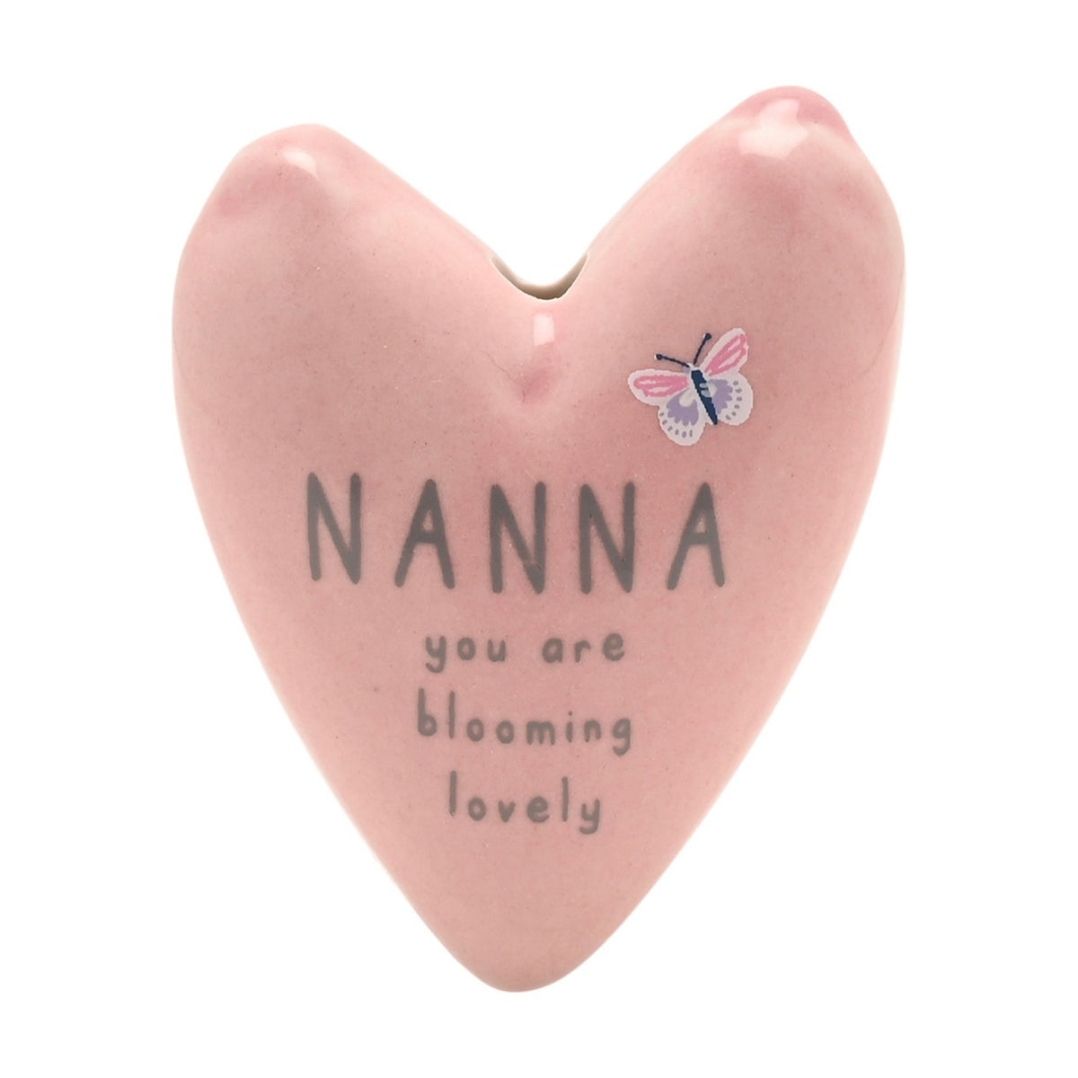 Pink glazed stoneware heart ornament reading "NANNA you are blooming lovely" in grey text, with a small pink and lilac butterfly design, shown on a white background.