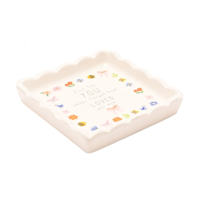 Square scalloped stoneware trinket dish in off white with a floral, bee and bow border and "Just for YOU, never forget how LOVED you are" text, shown on a white background.