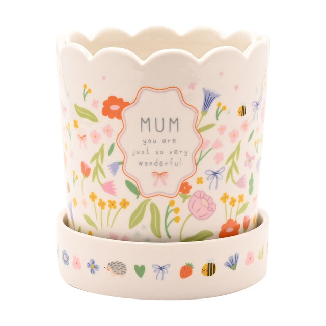 Off-white stoneware planter with scalloped rim and matching saucer, featuring a wildflower, bee and butterfly print and a framed MUM you are just so very wonderful panel.