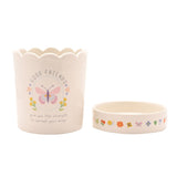 Off white stoneware round planter with scalloped rim, "Good Friends" butterfly and floral design, shown beside its matching decorated saucer on a plain background.