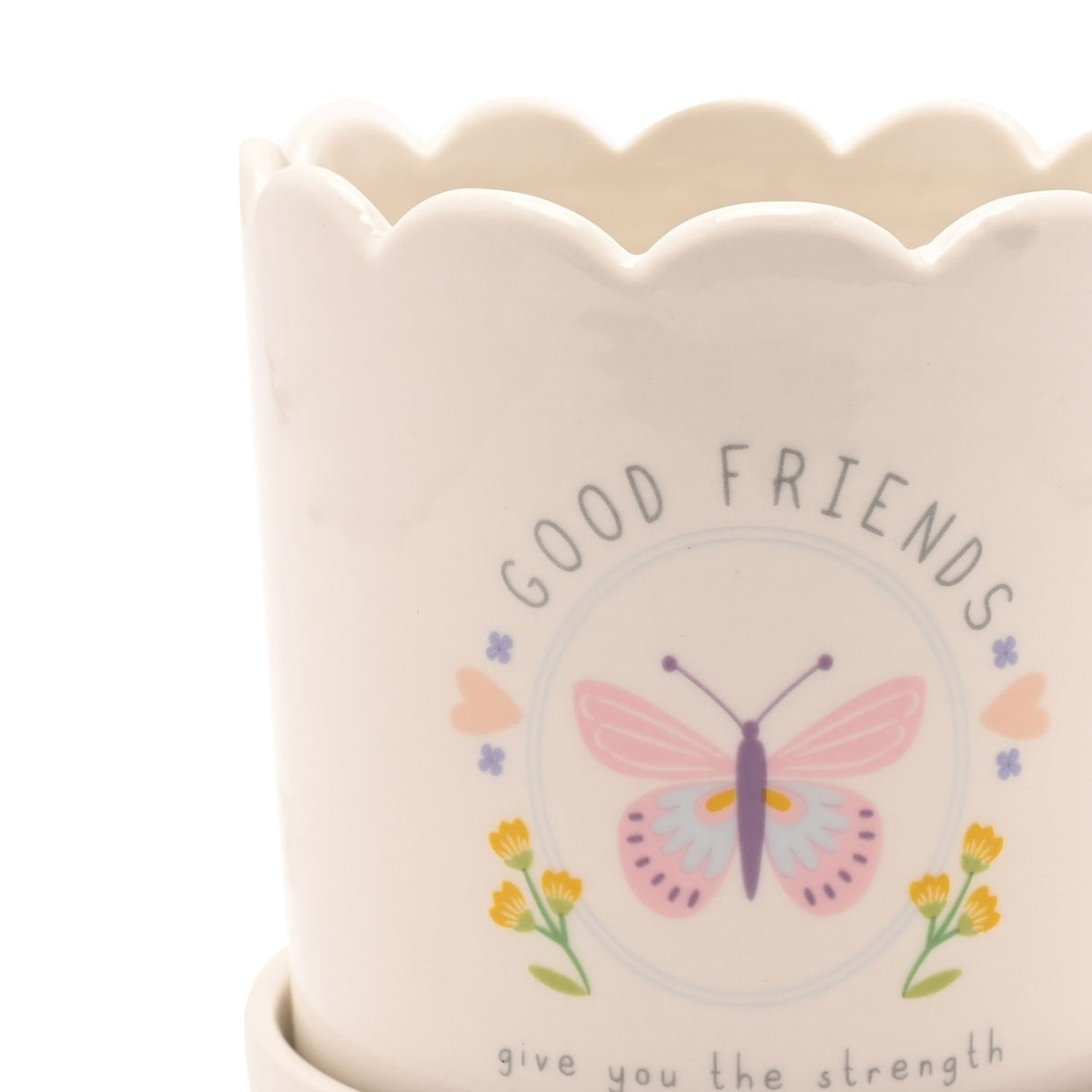 Close-up of the Good Friends Round Stoneware Planter in off white with scalloped rim, featuring a pastel butterfly, flowers and hearts design with "GOOD FRIENDS" text.