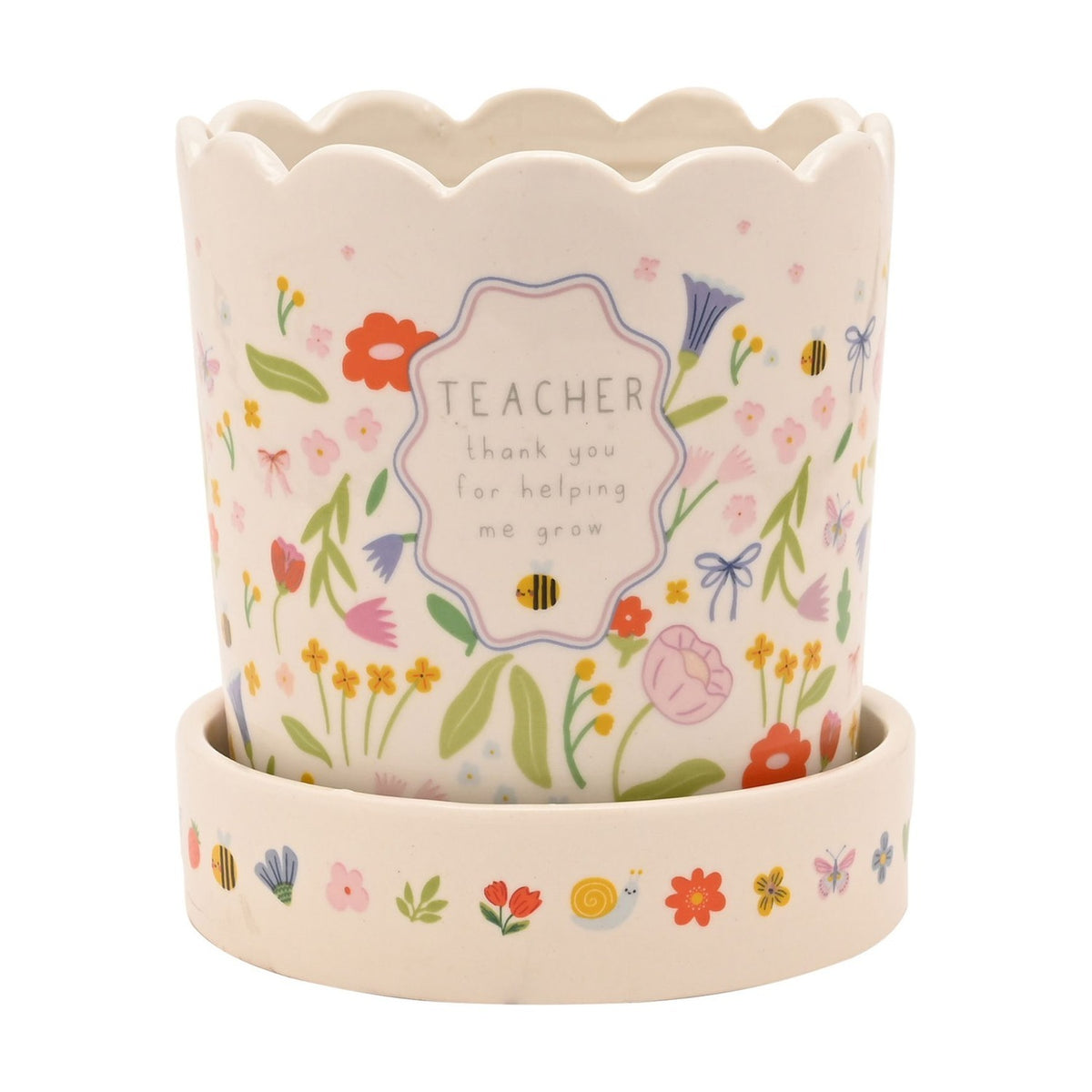 White stoneware planter with scalloped rim and matching saucer, decorated with a floral meadow print, bees and bows, reading "TEACHER thank you for helping me grow" on a plain background.